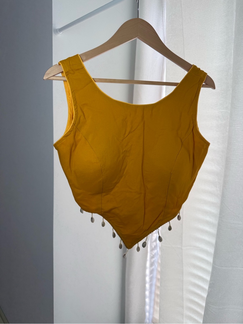 Mustard Yellow Sleeveless Blouse with Decorative Tassels
